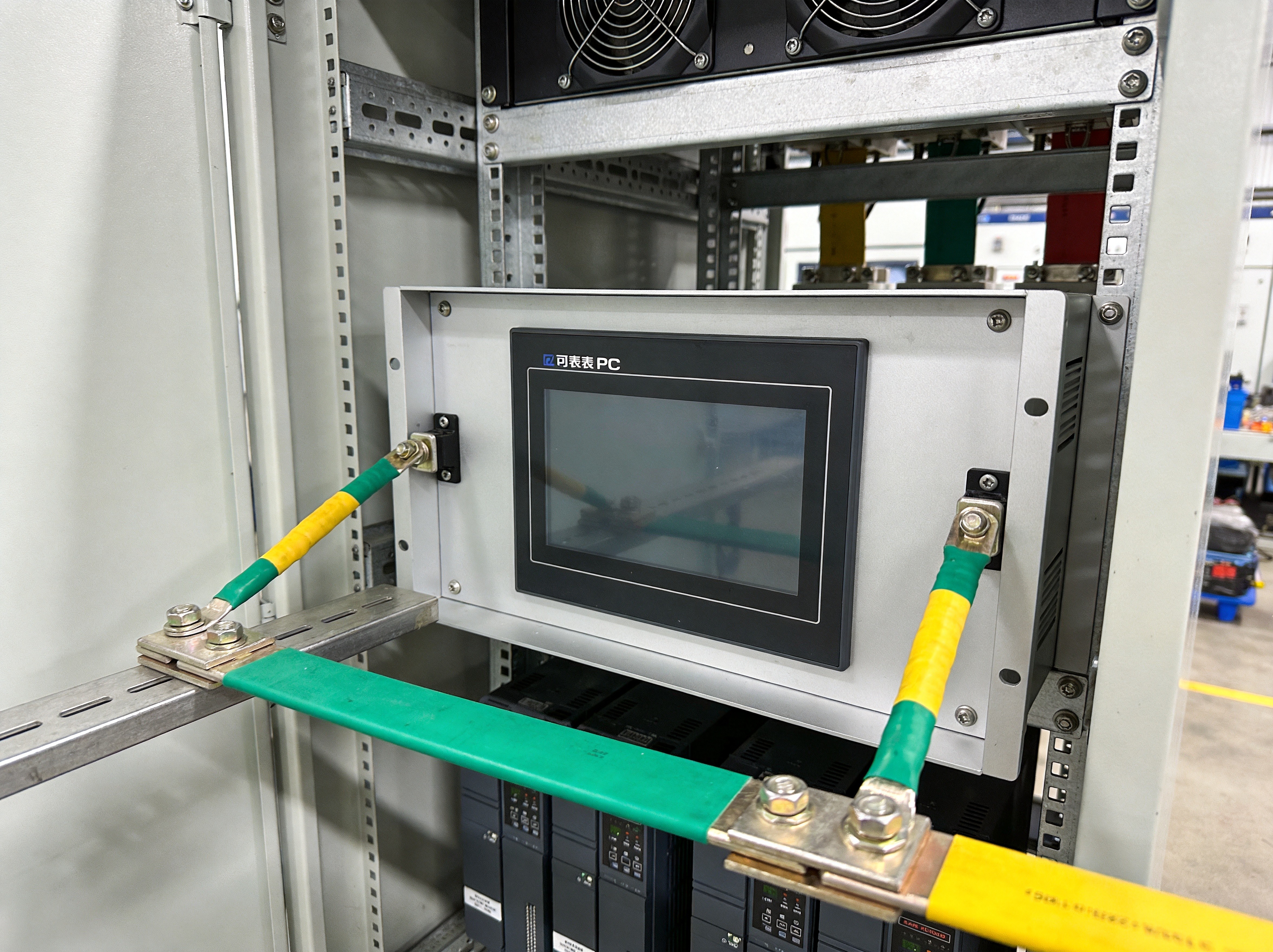 Close-up of industrial panel PC enclosure showing conductive gasket material and grounding points at the seam