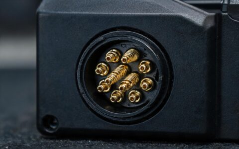 extreme macro of gold plated M12 connector contacts on a fanless industrial panel pc during contact inspection