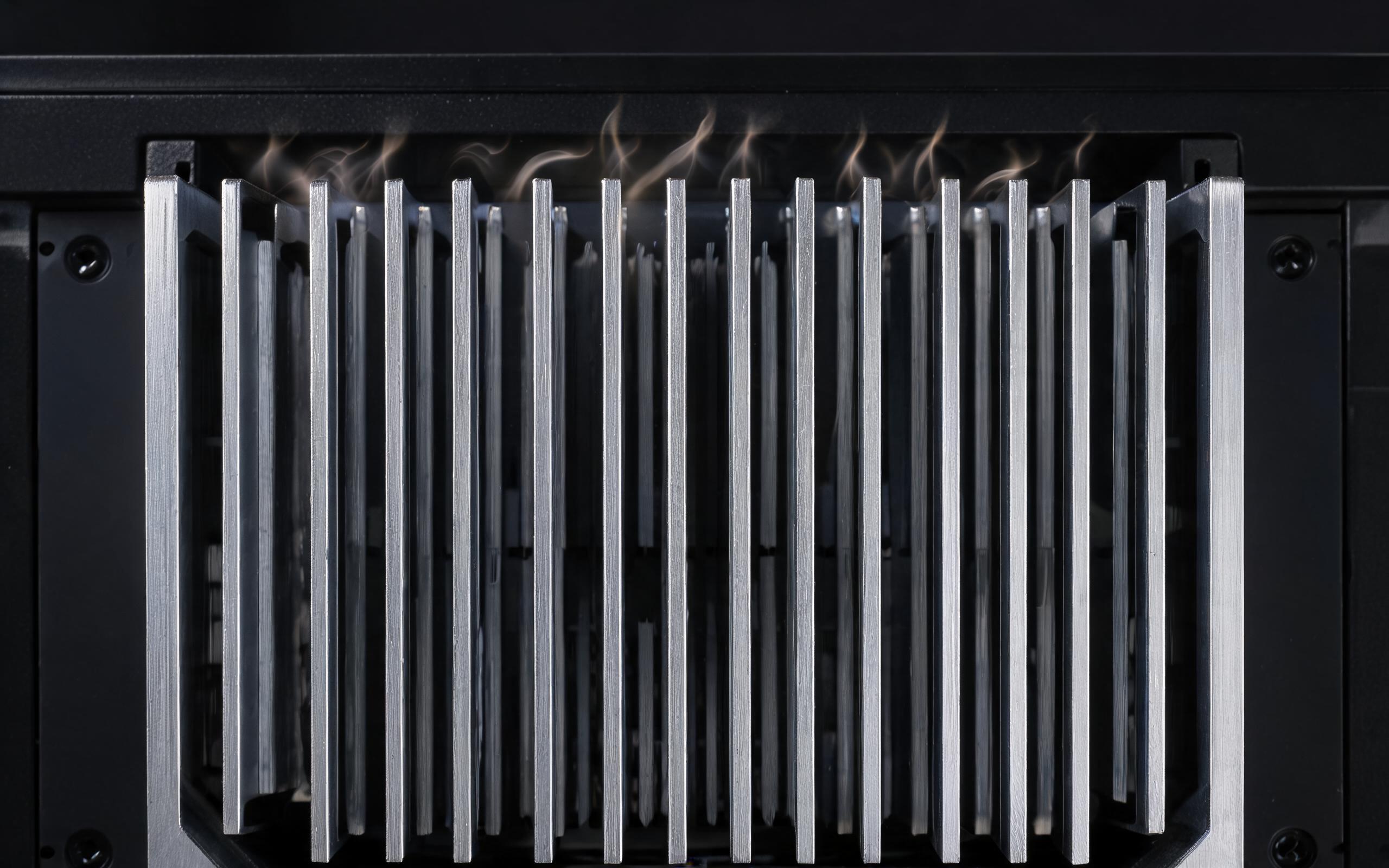close-up of a vertical extruded aluminum fin stack on the rear housing of a fanless panel pc with open gaps at both ends and warm air rising, industrial product photography, no text