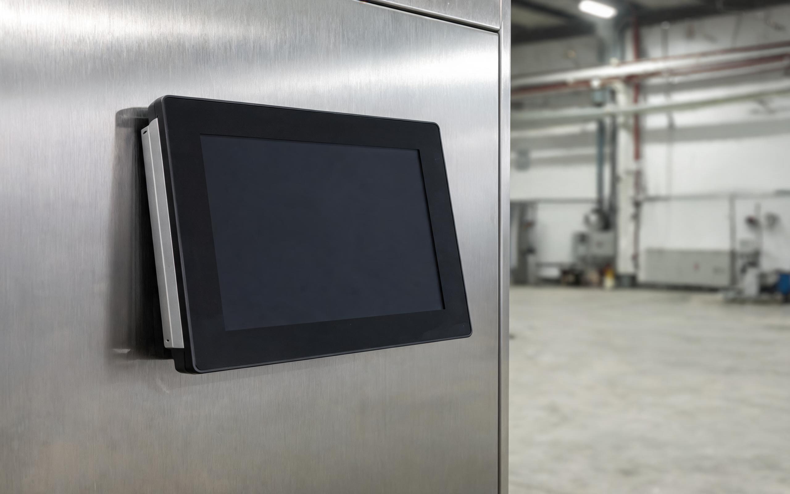 Read-only immutable root on a sealed panel PC sealed fanless industrial panel pc linux terminal panel-mounted in a stainless steel control cabinet with a closed front bezel, realistic factory engineering photography, dark screen no text