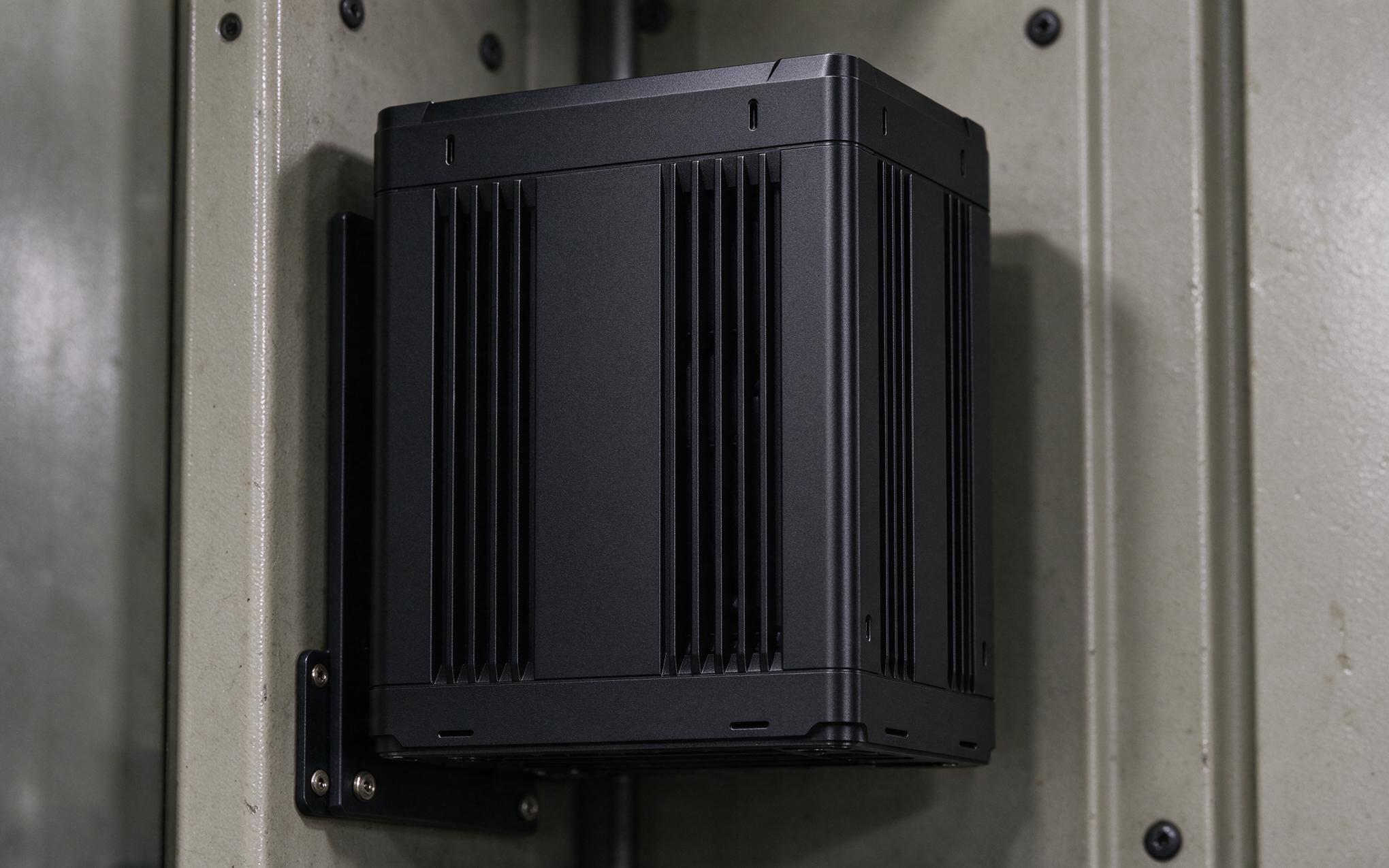 Vertical fin channels on a fanless industrial mini pc promoting chimney effect cooling