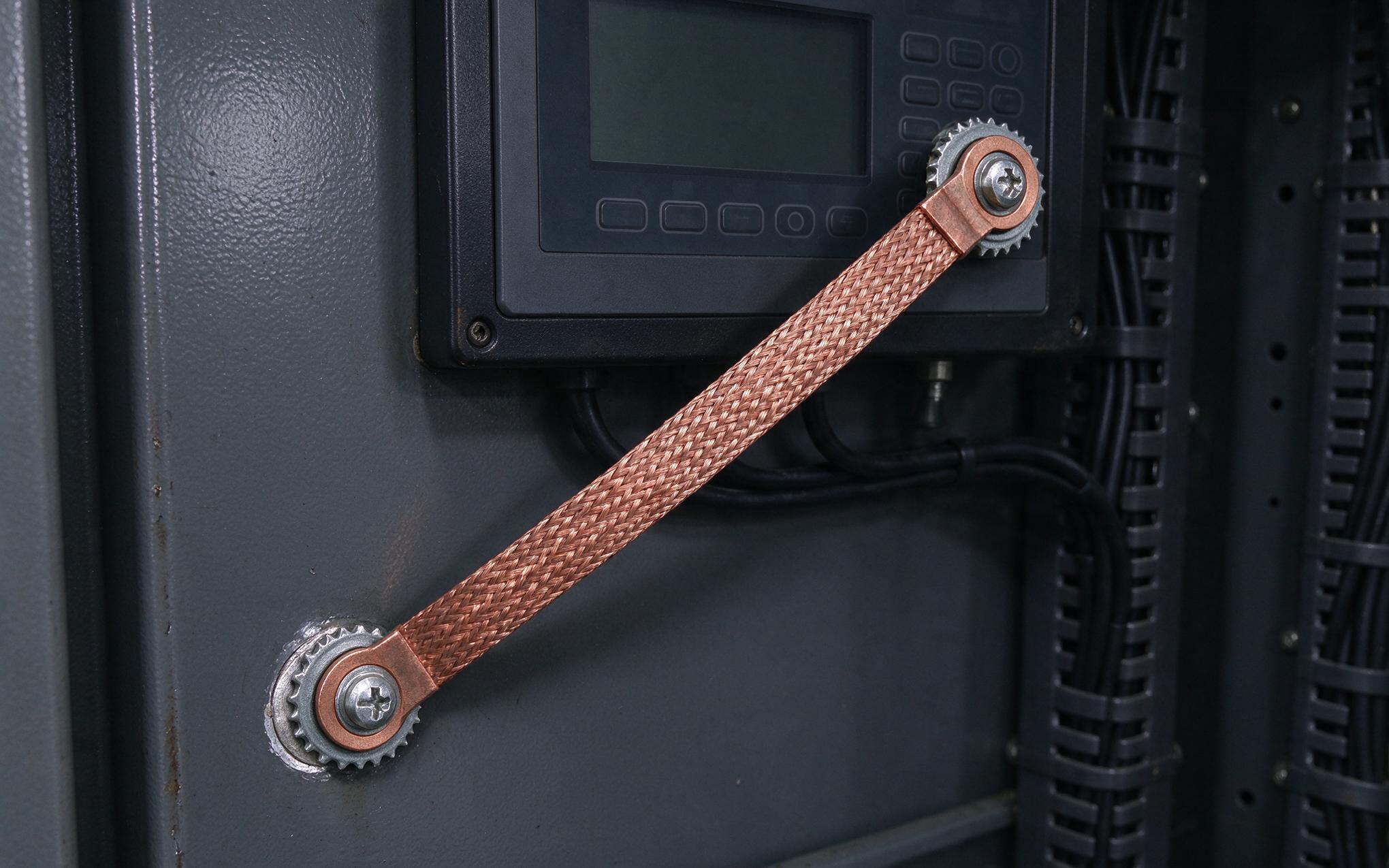 Braided Strap Chassis Bonding Detail braided ground strap bonding an industrial touch pc bezel to a painted steel cabinet door